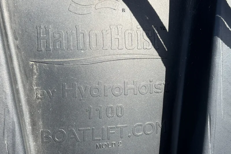 Slide: The Image of HarborHoist by HydroHoist boat lift, model 1100, embossed branding on surface. - 35