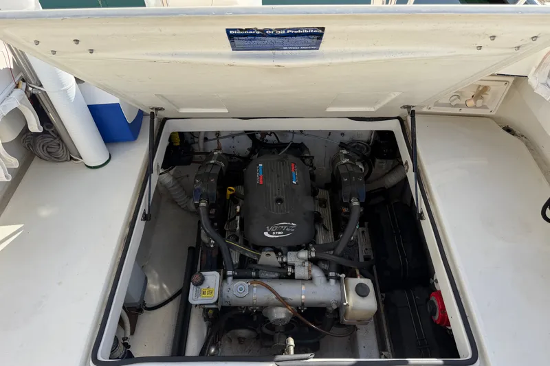 Slide: The Image of Engine compartment of a 1994 Skipjack 262 Flybridge boat, showcasing the motor and components. - 31