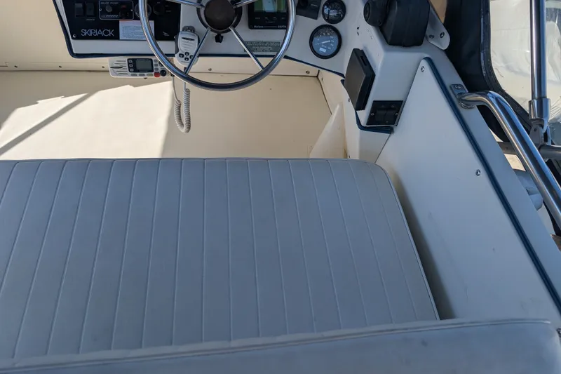 Slide: The Image of 1994 Skipjack 262 Flybridge boat interior with steering wheel and control panel. - 18