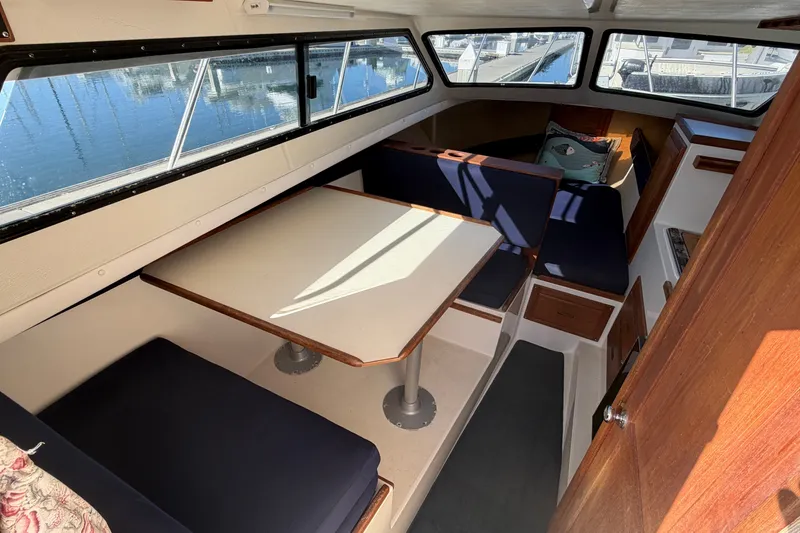 Slide: The Image of Interior of 1994 Skipjack 262 Flybridge boat with seating and table. - 17