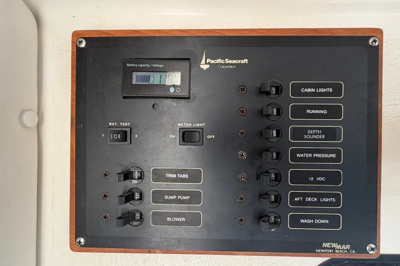 Slide: The Image of Control panel of a 1994 Skipjack 262 Flybridge boat with various switches and voltage display. - 21