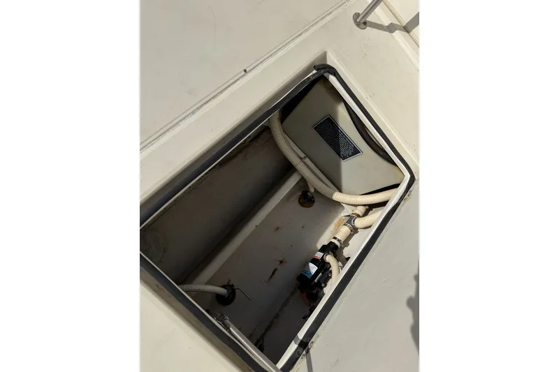 Slide: The Image of Open hatch of a 1994 Skipjack 262 Flybridge boat, showing internal components. - 40