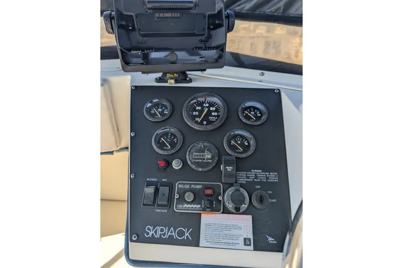 Slide: The Image of Control panel of a 1994 Skipjack 262 Flybridge boat with gauges and switches. - 20