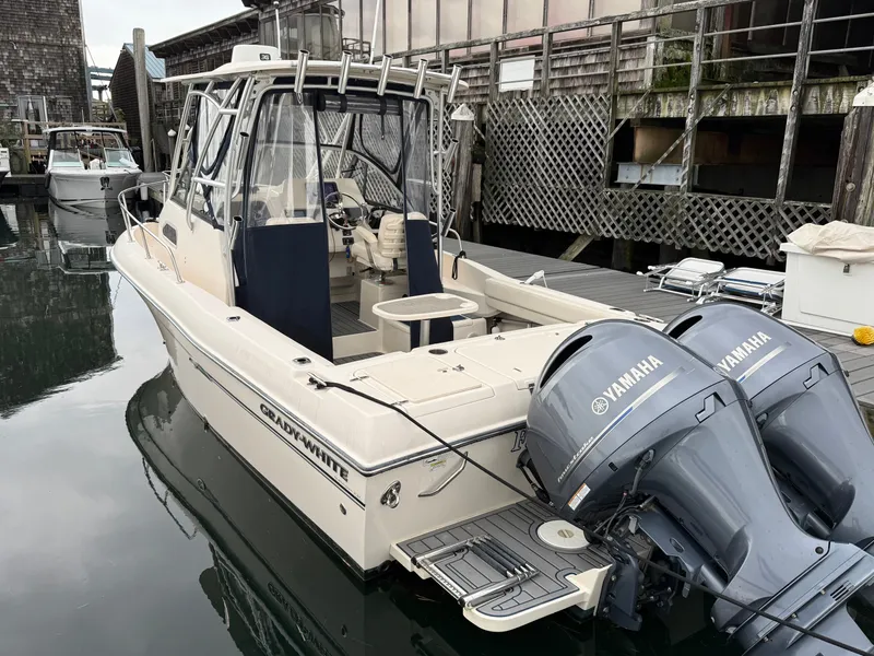 Slide: The Image of A 2015 Grady-White Gulfstream 232 is docked. It features twin Yamaha outboard engines. - 3