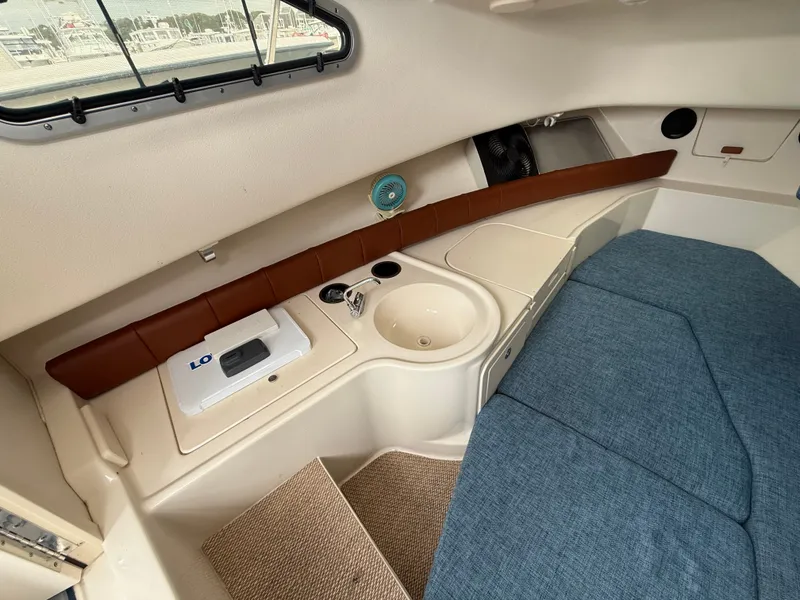 Slide: The Image of Interior of the 2015 Grady-White Gulfstream 232 with sink and blue upholstery. - 32