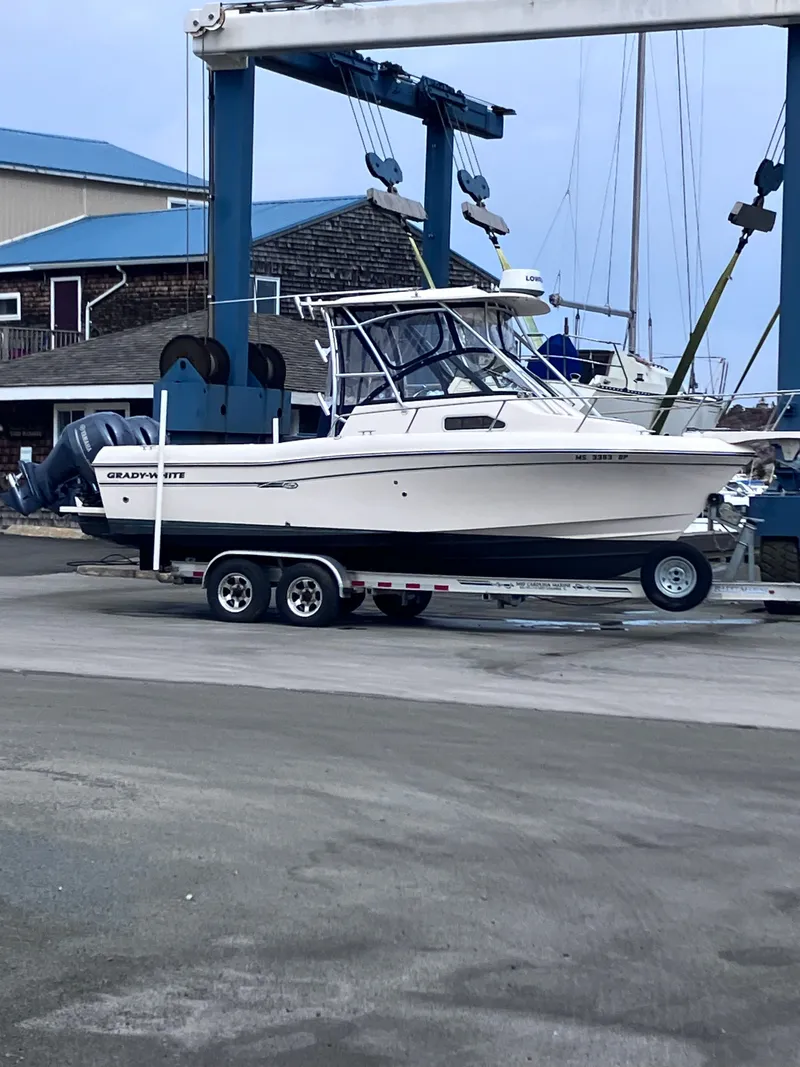 Slide: The Image of A 2015 Grady-White Gulfstream 232 on a trailer in a harbor area. - 37