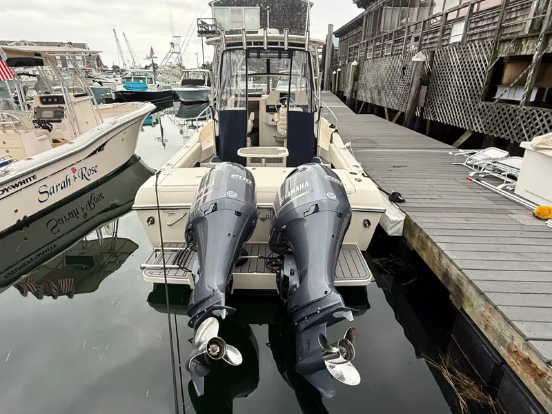 Slide: The Image of 2015 Grady-White Gulfstream 232 with twin outboard engines, docked at a wooden pier. - 4