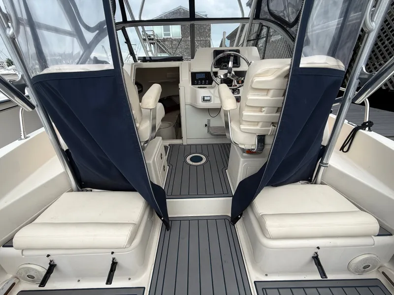 Slide: The Image of Interior of a 2015 Grady-White Gulfstream 232 with two cushioned seats and a helm station. - 19