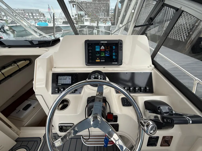 Slide: The Image of The cockpit of a 2015 Grady-White Gulfstream 232 with modern electronics and controls. - 21