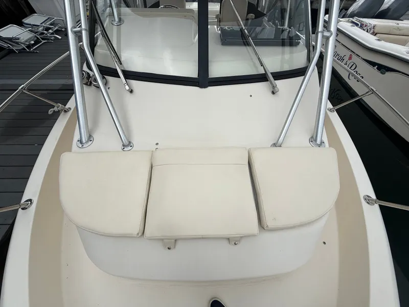Slide: The Image of The image shows the cockpit of a 2015 Grady-White Gulfstream 232 with beige cushions. - 13