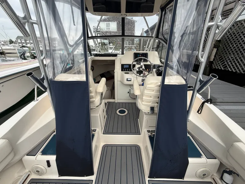 Slide: The Image of The cockpit of a 2015 Grady-White Gulfstream 232 with two seats and a helm station. - 17