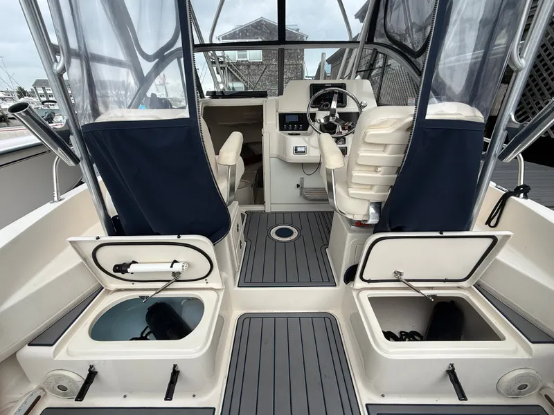 Slide: The Image of The image shows the cockpit of a 2015 Grady-White Gulfstream 232 with seats and storage compartments. - 18