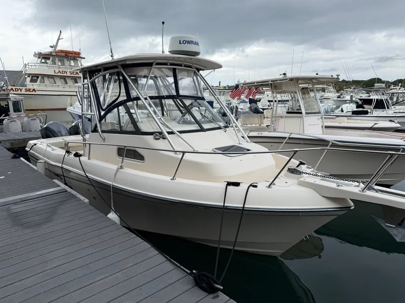 Slide: The Image of A 2015 Grady-White Gulfstream 232 docked. It features a sturdy design and a hardtop. - 8