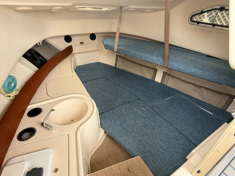 Slide: The Image of Interior of the 2015 Grady-White Gulfstream 232 with blue cushions and a sink. - 29