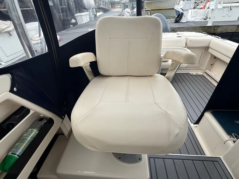 Slide: The Image of A beige captain's chair on a 2015 Grady-White Gulfstream 232 boat. - 36
