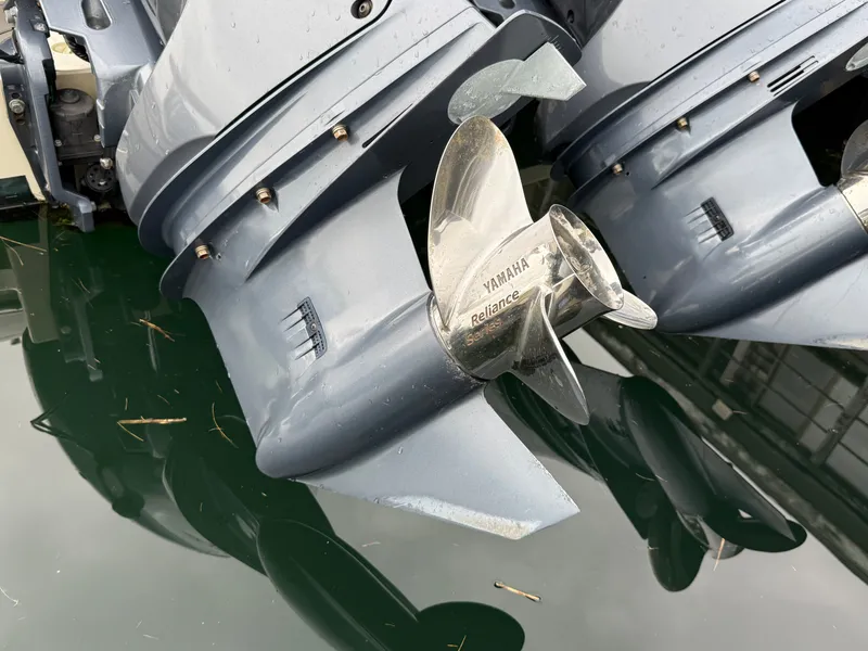 Slide: The Image of Close-up of two Yamaha outboard motors on a boat, reflecting in the water. - 5