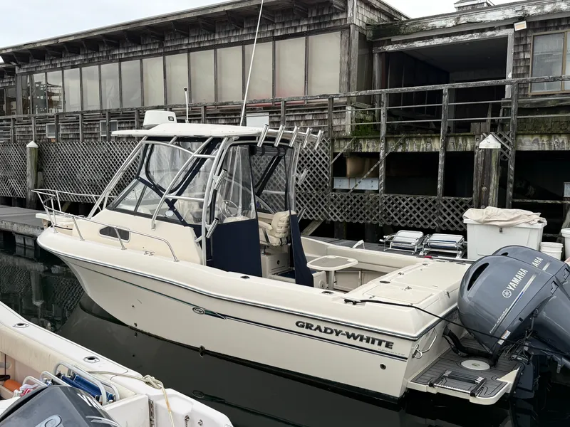 Slide: The Image of Grady-White Gulfstream 232, 2015 model, docked. Features a hardtop and outboard motor. - 2
