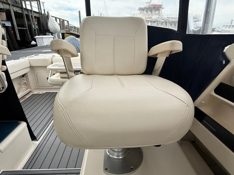 Slide: The Image of A beige captain's chair on a Grady-White Gulfstream 232 boat, surrounded by marine equipment. - 35