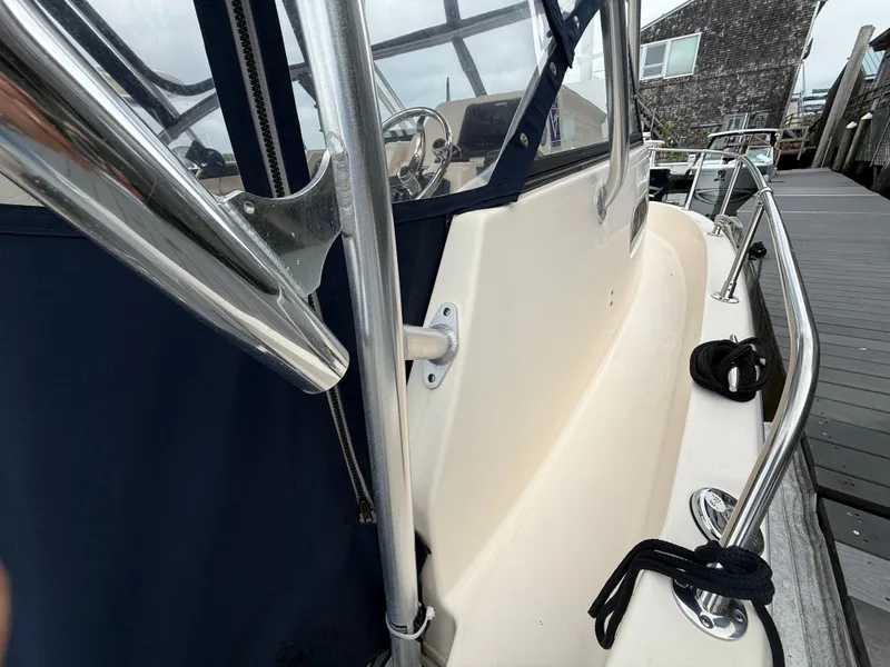 Slide: The Image of Close-up of a Grady-White Gulfstream 232 boat with blue cover and stainless steel railing. - 10