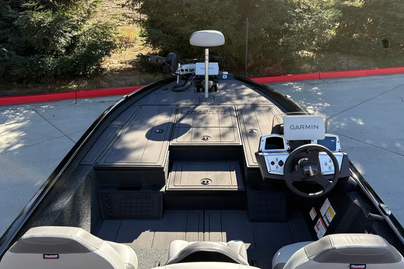 Slide: The Image of 2027 Tracker Savage 215 boat interior with Garmin navigation system and dual seats. - 16