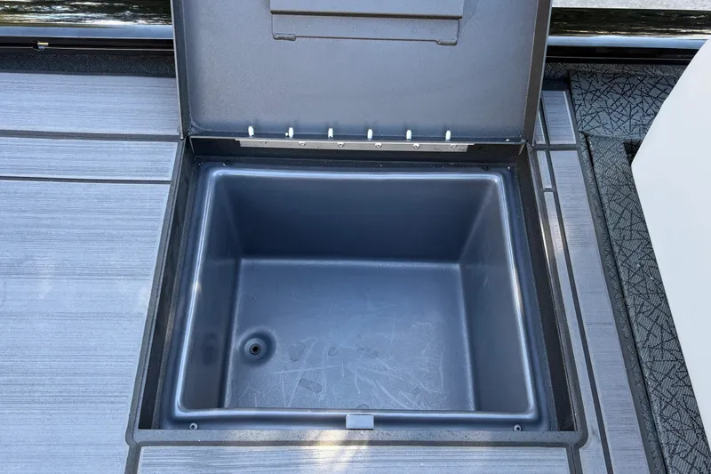 Slide: The Image of Open storage compartment on 2027 Tracker Savage 215 boat deck. - 35