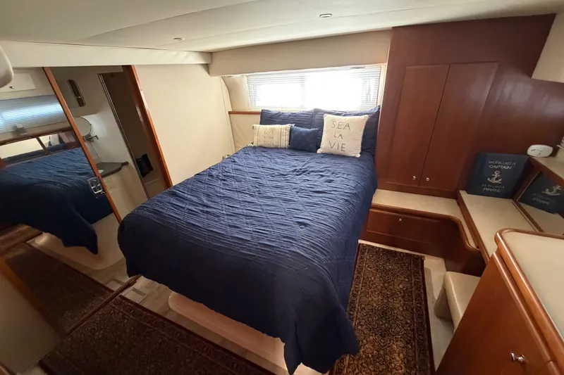 Slide: The Image of Luxurious bedroom in 1997 Carver 445 Aft Cabin Motor Yacht with nautical decor. - 17