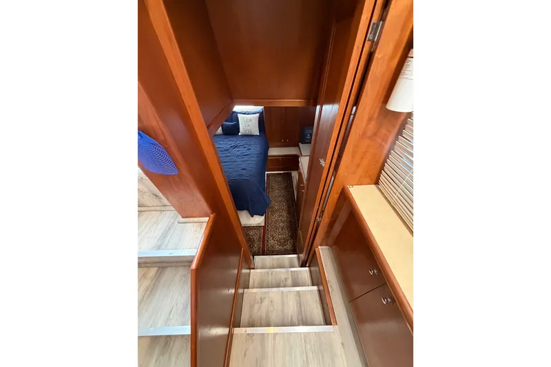 Slide: The Image of Interior view of 1997 Carver 445 Aft Cabin Motor Yacht, featuring cozy bedroom and wooden cabinetry. - 18