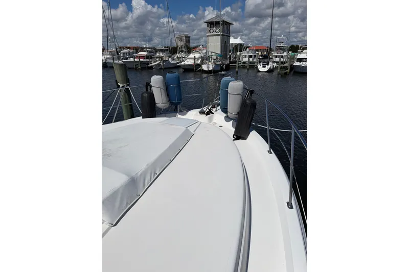 Slide: The Image of 1997 Carver 445 Aft Cabin Motor Yacht docked at marina, clear sky, calm water. - 32