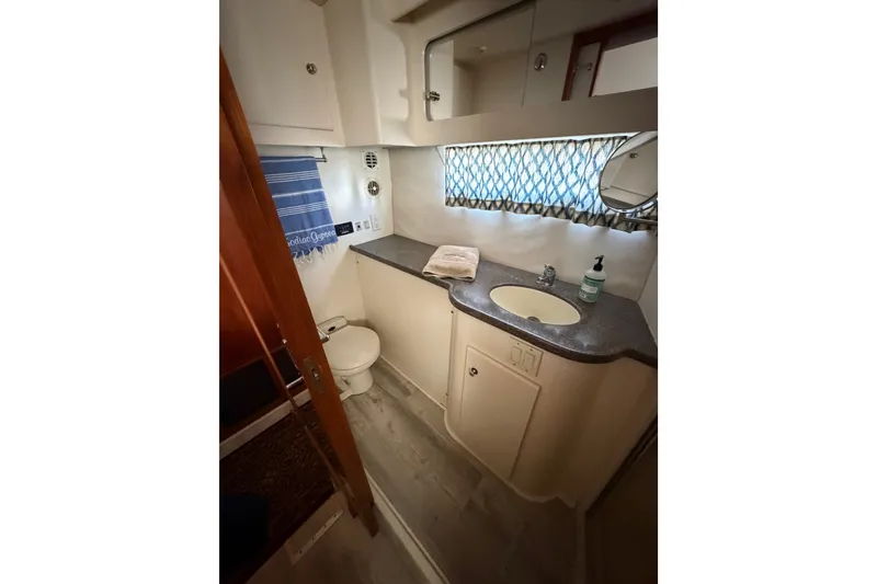 Slide: The Image of Bathroom interior of 1997 Carver 445 Aft Cabin Motor Yacht, featuring sink and toilet. - 20
