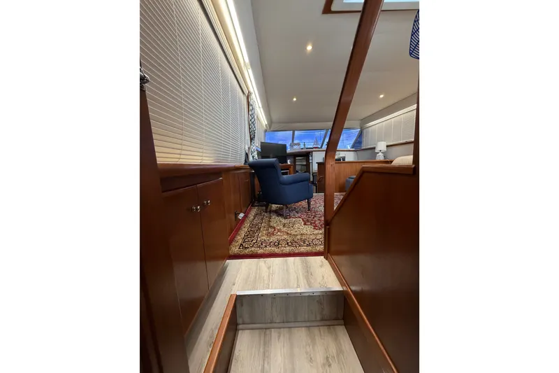 Slide: The Image of Interior of 1997 Carver 445 Aft Cabin Motor Yacht with elegant wood finish and seating area. - 14