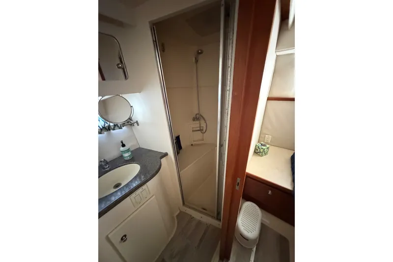 Slide: The Image of Bathroom interior of 1997 Carver 445 Aft Cabin Motor Yacht, featuring sink and shower. - 21