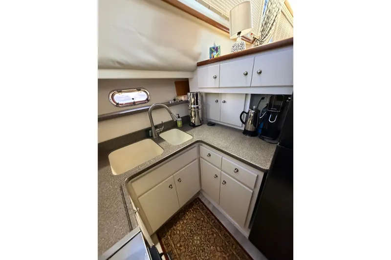 Slide: The Image of Compact kitchen in 1997 Carver 445 Aft Cabin Motor Yacht with modern appliances and ample storage. - 19