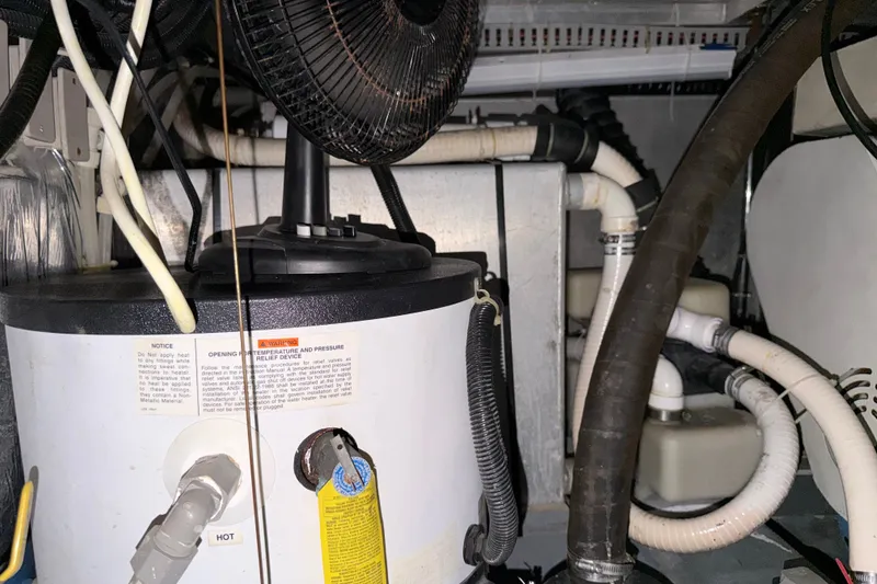 Slide: The Image of Engine room of 1997 Carver 445 Aft Cabin Motor Yacht with water heater and fan. - 37