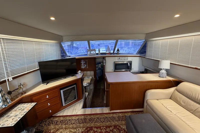 Slide: The Image of Interior of 1997 Carver 445 Aft Cabin Motor Yacht with cozy seating and modern amenities. - 25