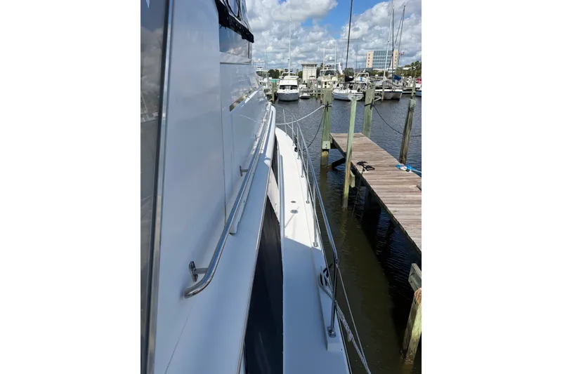 Slide: The Image of 1997 Carver 445 Aft Cabin Motor Yacht docked at marina under blue sky. - 33