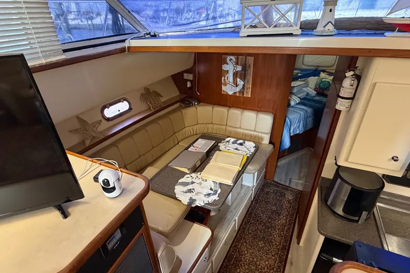 Slide: The Image of Interior of 1997 Carver 445 Aft Cabin Motor Yacht with cozy seating and nautical decor. - 24