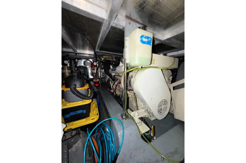 Slide: The Image of Engine room of 1997 Carver 445 Aft Cabin Motor Yacht with visible machinery and equipment. - 34