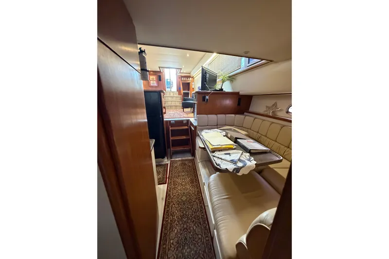 Slide: The Image of Interior of 1997 Carver 445 Aft Cabin Motor Yacht with cozy seating and table. - 16