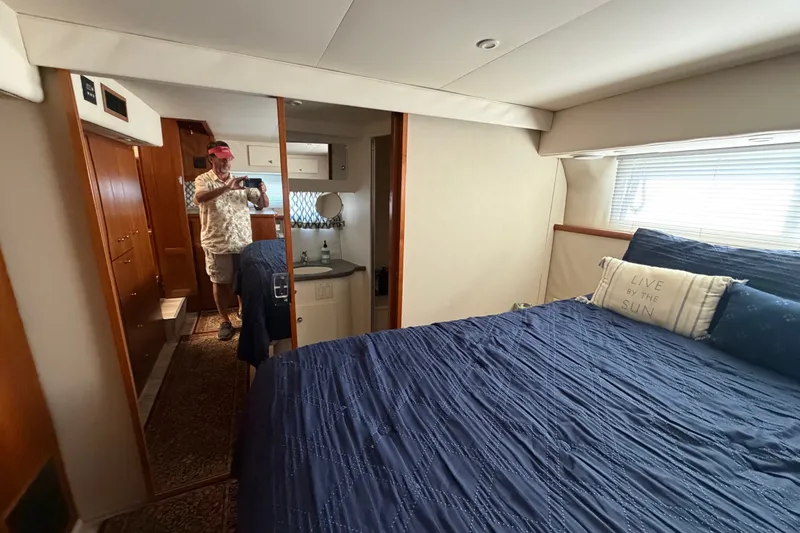 Slide: The Image of Interior of 1997 Carver 445 Aft Cabin Motor Yacht with cozy bedroom and mirror. - 22