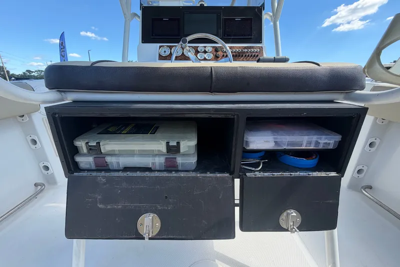 Slide: The Image of Storage compartments on a 2021 Key Largo 2650WI boat, featuring organized tackle boxes. - 22