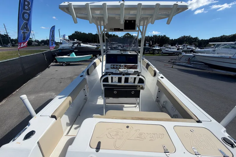 Slide: The Image of 2021 Key Largo 2650WI boat on display at a dealership, sunny day. - 17