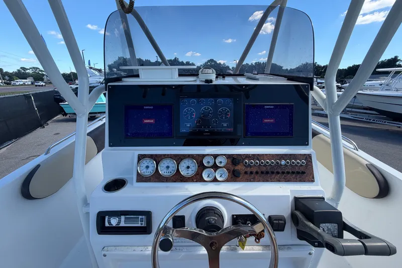 Slide: The Image of 2021 Key Largo 2650WI boat dashboard with navigation screens and controls. - 30