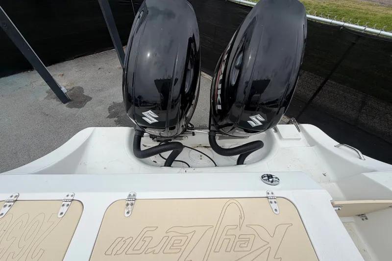 Slide: The Image of 2021 Key Largo 2650WI boat with dual Suzuki outboard motors. - 18