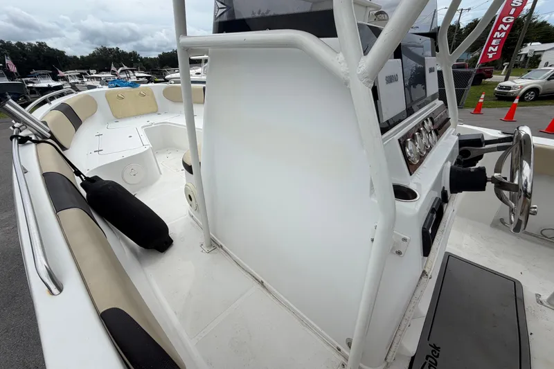 Slide: The Image of 2021 Key Largo 2650WI boat interior with steering console and seating area. - 14
