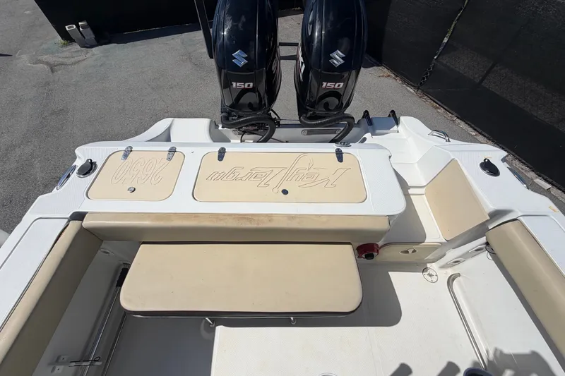 Slide: The Image of 2021 Key Largo 2650WI boat with dual Suzuki 150 engines, beige seating, and deck view. - 68