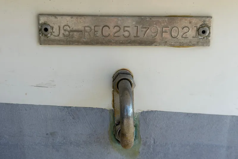 Slide: The Image of 2021 Key Largo 2650WI boat hull identification number and metal hook detail. - 81