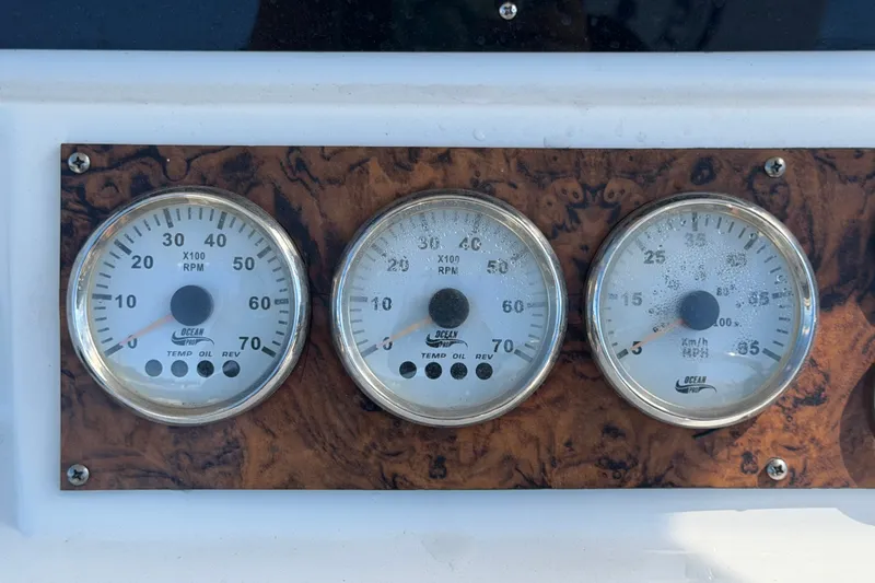 Slide: The Image of Boat dashboard with three analog gauges on a Key Largo 2650WI, 2021 model. - 35