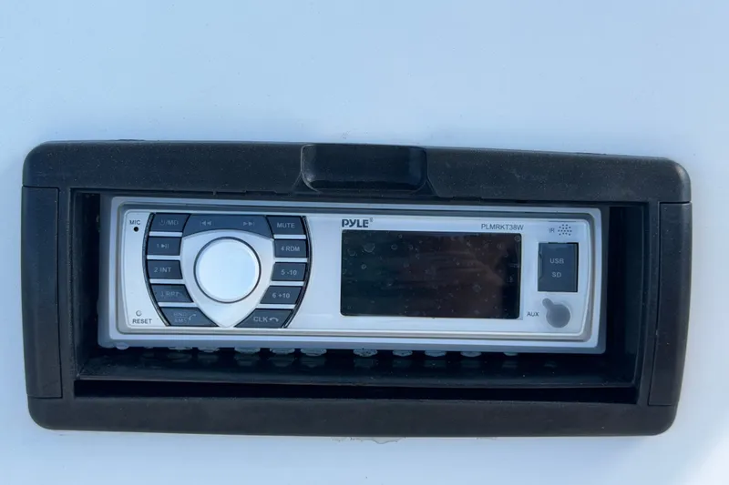 Slide: The Image of Pyle marine stereo system on a 2021 Key Largo 2650WI boat dashboard. - 38