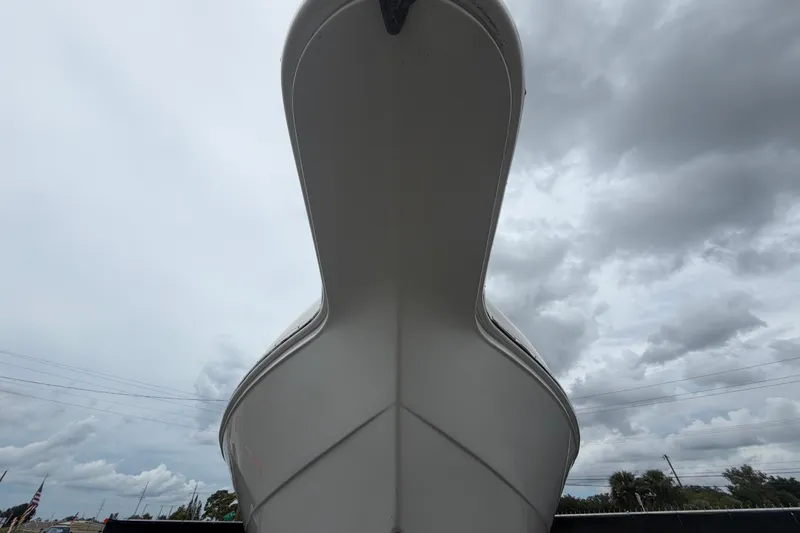 Slide: The Image of 2021 Key Largo 2650WI boat viewed from below against cloudy sky. - 7