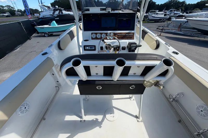 Slide: The Image of 2021 Key Largo 2650WI boat interior with steering console and rod holders. - 20